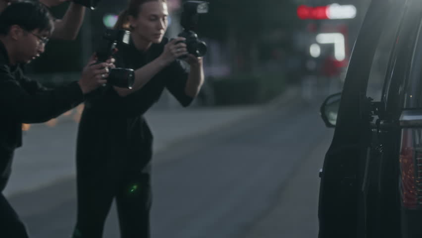 Team of paparazzi shooting young Biracial superstar and her security getting out of expensive black car