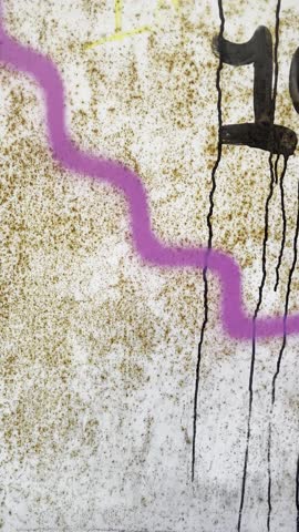 Colourful graffiti on wall at the Lewisham Centre London. Closeup street art drawing with aerosol colour spray. Urban subculture self expression modern art concept.