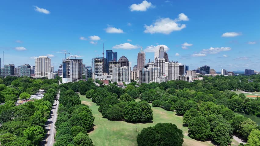Drone shot pushing in on Piedmont Park and Midtown in Atlanta, Georgia.