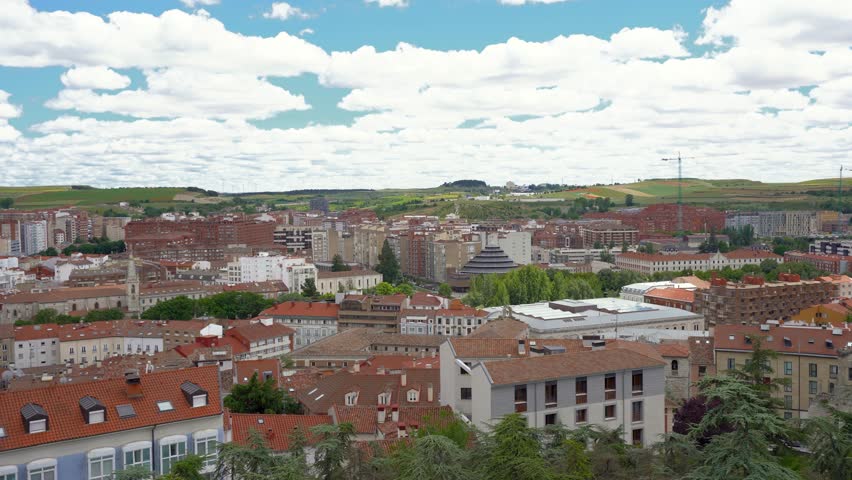 Panoramic top view of city center of Burgos, Spain. View of Cathedral of Burgos. Rooftops of historic and medieval Spanish city. Camera panning left. Famous travel destination. Cloudy day. Stabilized