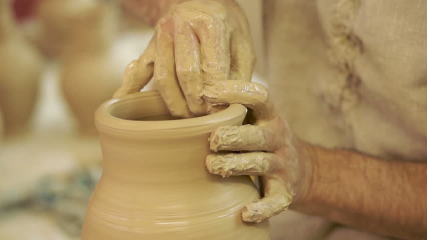 Potter works. Crockery creation process in pottery on potters' wheel