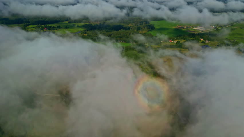 A Landscape of Mist-shrouded, Lush Greenery in the Mountains, Highlighted by a Visible Glory (Optical Phenomenon) - Aerial Drone Shot