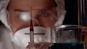 Scientist examining syringe and beakers, mathematical equations animation over scene. Laboratory, research, science, experiment, analysis, education - Powered by Shutterstock - Get 15% off with code: PIKWIZARD15