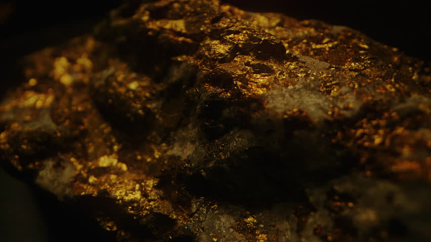 Raw Gold Ore Against a Dark Background - Close Up