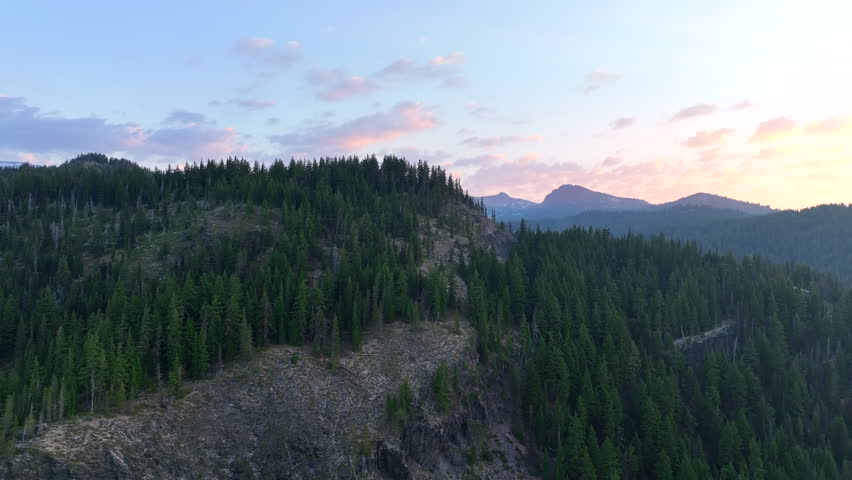 A summer sunrise illuminates the landscape around Three Sisters mountains, Oregon. These mountains and their surrounding forests, near Bend, provide exceptional hiking, biking, climbing, and camping.