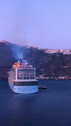 Greece Islands, cruise ship docked near Santorini island on a cruise vacation in Mediterranean.