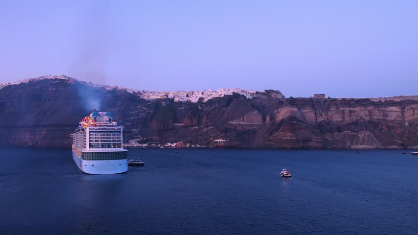 Greece Islands, cruise ship docked near Santorini island on a cruise vacation in Mediterranean.