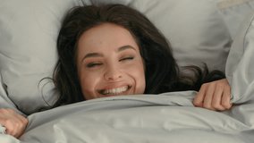 Close up face happy woman laughing smiling rejoice flirt girl looking duvet peek out female toothy dental smile bedroom home pleasure tenant glad enjoying joy bed positive dentistry delight homeowner - Powered by Shutterstock - Get 15% off with code: PIKWIZARD15