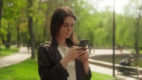 Thoughtful woman walking in park using mobile phone smartphone gadget texting online chat connection smiling happy sms thinking technology web social networks stroll typing city outside female girl - Powered by Shutterstock - Get 15% off with code: PIKWIZARD15
