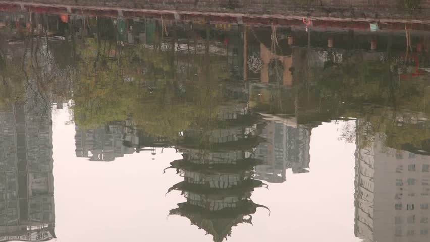 reflection on kin water river of Chengdu capital city of the Chinese province of Sichuan, ancient traditional chinese pagoda and modern skyline skyscraper building
