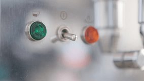 A man switches on an espresso machine, bright lights glowing, as the aroma of fresh coffee fills the stylish café. - Powered by Shutterstock - Get 15% off with code: PIKWIZARD15