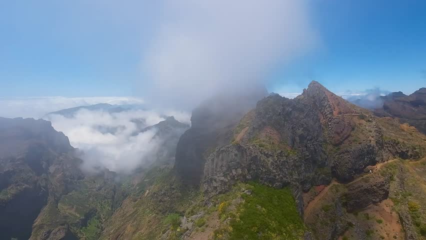 Captivating drone shots of Pico do Pico’s stunning vistas. Perfect for nature documentaries, travel guides, and adventure films. Zoom out. Wide high altitude.
