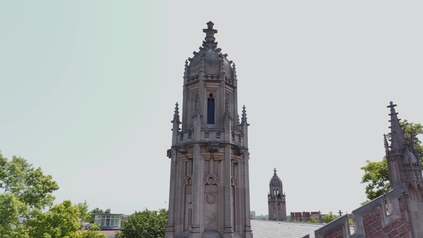 Panning around a tower or steeple at the Graham Chapel Church in Washington University near St. Louis, Missouri inside of a college campus.