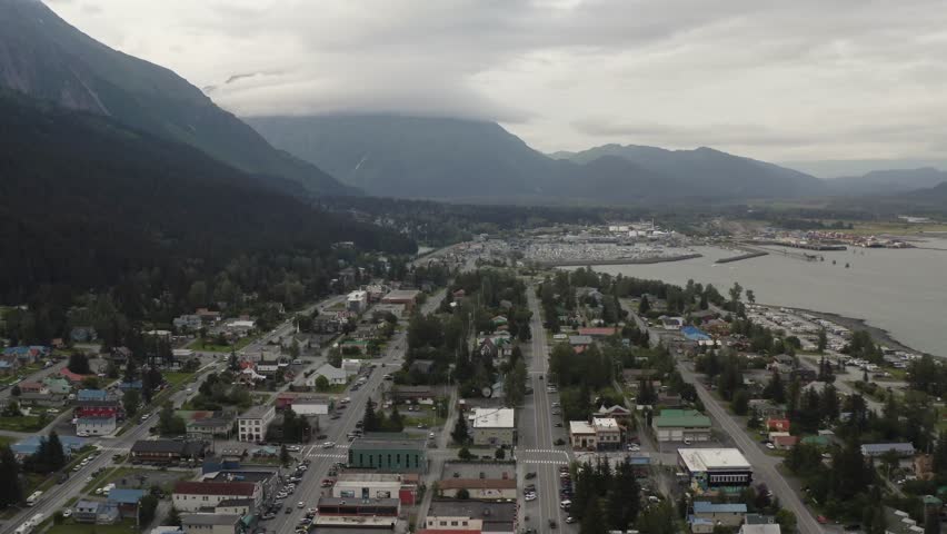 Downtown Seward, Alaska harbor town with boats, buildings, and mountain landscape along Resurrection Bay on the Kenai Peninsula of Alaska - 4K Drone