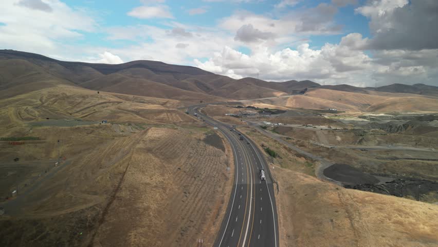 Aerial of state Highway 95 in Lewiston Idaho through brown grassy hills in fall