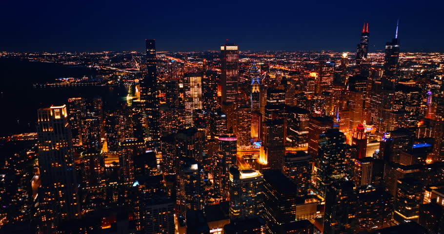 Amazing illumination of the modern Chicago, Illinois, the USA at night. Beautiful cityscape with lights on from aerial perspective.