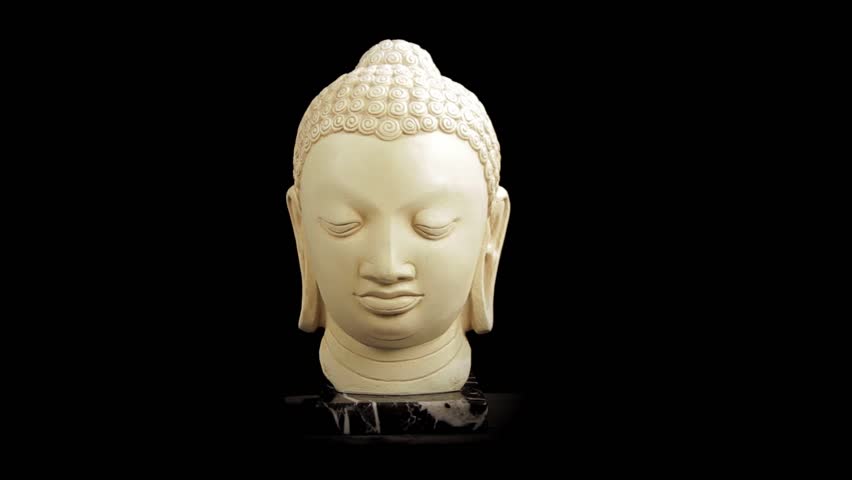 Bust of Buddha sculpture rotating over black background - Looping Video