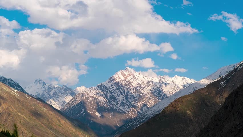 4K Timelapse of clouds moving over snowy mountains during sunset at Darcha, Lahaul, India. Mesmerizing Himalaya landscape.  Time lapse of sky and clouds during the sunset