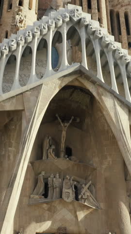 Basilica and Expiatory Church of the Holy Family, Barcelona - Spain. Stock. Facade view of Birth at Sagrada Familia Temple from Gaudi Square in Barcelona city