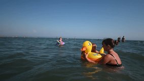Family Fun at the Beach: Mother and Daughter on Inflatable Duck in Ulcinj, Montenegro. - Powered by Shutterstock - Get 15% off with code: PIKWIZARD15