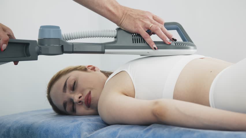 A young woman undergoing advanced superinductive magnetic therapy in a modern clinic. Perfect for highlighting cutting-edge medical treatments and wellness innovation.