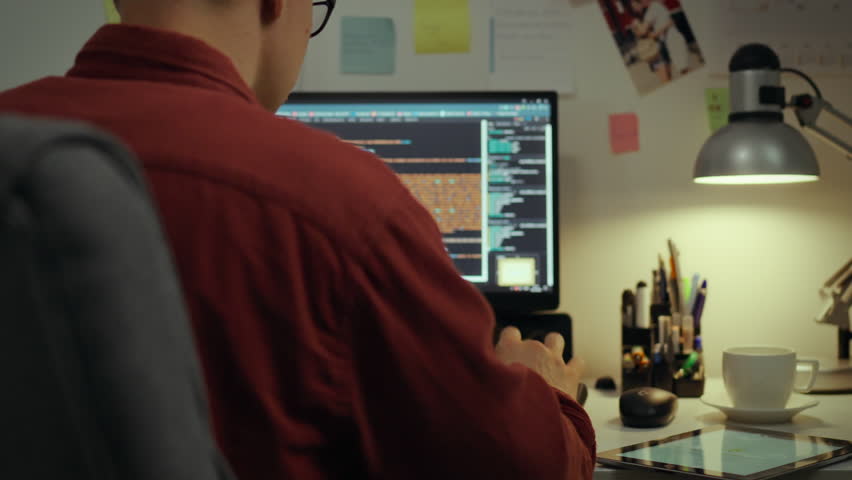 Screen. Experienced specialist using technologies concentrated programming making edits in the evening room. Camera movement home worker corrects program code writes code ai, web development