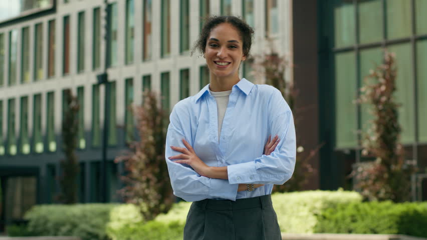Portrait African American ethnic student girl freelancer female entrepreneur business woman lady employer manager businesswoman in city outside outdoors urban confident smiling folded crossed hands