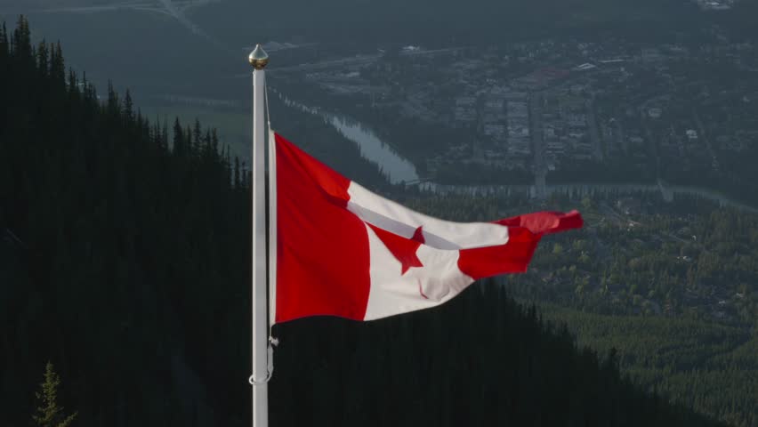 Canadian flag on Sulphur Mountain in Banff National Park with town view
