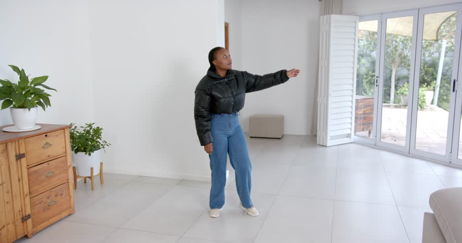 High speed photography for dynamic scenes, in living room, woman in casual outfit indoors.people, movement, full body, reaching.