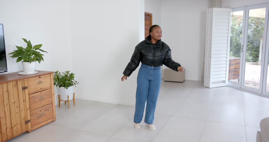 High speed photography for dynamic scenes, in living room, woman in casual outfit indoors.people, movement, full body, reaching.