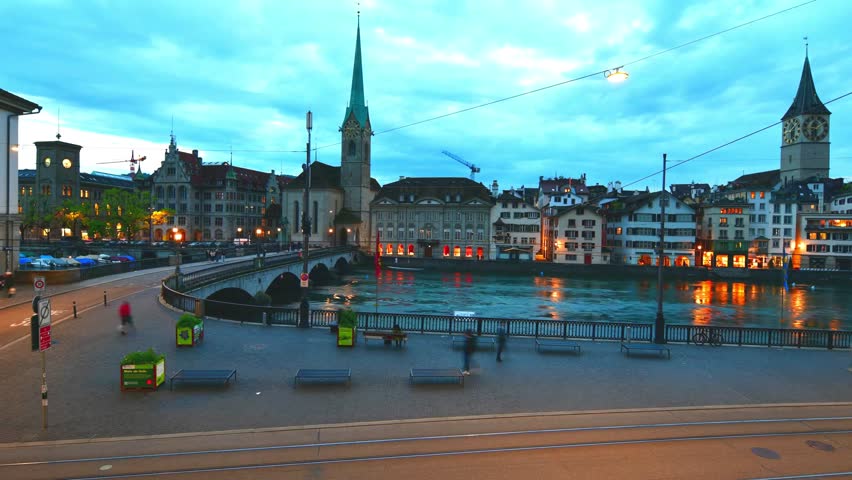 Timelapse beautiful night view of  Fraumunster church and stone bridge over the Limmat river, Historic city town in Zurich, Switzerland.