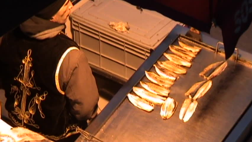 Fisherman is cooking his pompanos and sell them