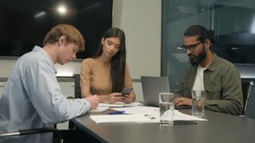 Business partners colleagues men woman office coworking group male female girl guys interns writing working conference table multiethnic diverse employees businessmen businesswoman boring use devices - Powered by Shutterstock - Get 15% off with code: PIKWIZARD15