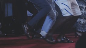 Dancing shoes of a couple, couples dancing traditional latin argentinian dance milonga in the ballroom, tango salsa bachata kizomba lesson, festival on wooden floor, purple, red and violet lights - Powered by Shutterstock - Get 15% off with code: PIKWIZARD15