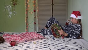 new year, christmas holiday, decoration, christmas tree decorations, gifts, pampering, family, newborn sweater, door decoration, wreath, santa hat, teenagers, childhood, boy unseals gift - Powered by Shutterstock - Get 15% off with code: PIKWIZARD15