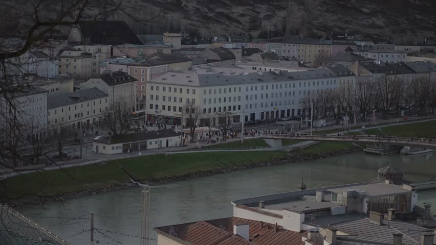 Salzburg, Austria. Cityscape over river in Salzburg on sunny winter day. Salzach riverfront. Embankment of Salzach river in Salzburg old town, Austria, Europe. Town view
