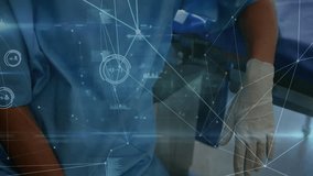 Animation of network of connections over biracial female surgeon with face mask. Medicine, technology and digital interface concept digitally generated video. - Powered by Shutterstock - Get 15% off with code: PIKWIZARD15