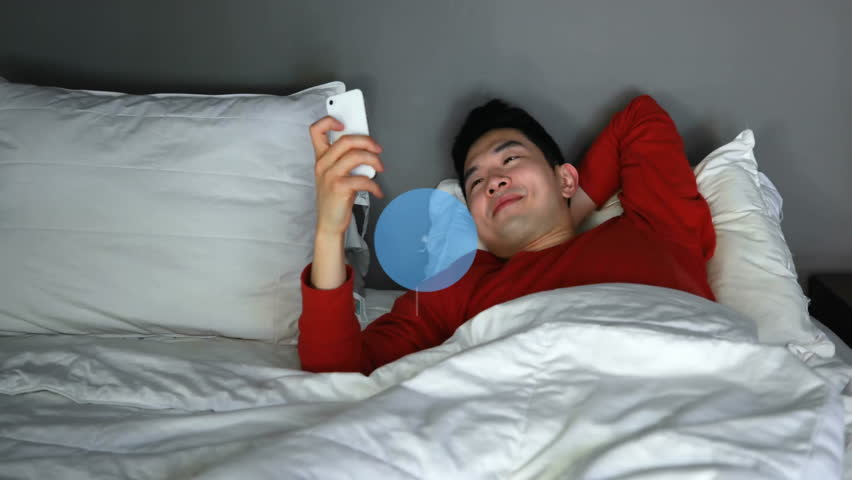 Animation of network of connections with icons over asian man using smartphone. Business, technology and digital interface concept digitally generated video.