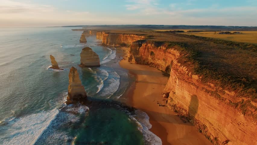 The rock stacks that comprise the Twelve Apostles at sunset in Port Campbell National Park, aerial view in slow motion.