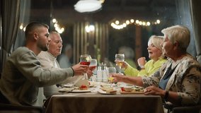 Caucasian Family Clinking Glasses of Juice During Dinner at Restaurant. Concept of Dining, Togetherness, Cheers, Bonding, Toasting, Extended Family, Reunion, Drinking, Celebration, Relationship - Powered by Shutterstock - Get 15% off with code: PIKWIZARD15