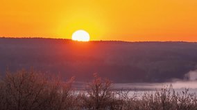 Timelapse video of sun rising above horizon in the morning. Spring morning video of sun rising illuminating the valley, melting fog - Powered by Shutterstock - Get 15% off with code: PIKWIZARD15