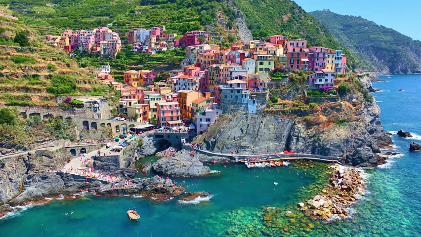 Cinque terra aerial view on a sunny day, Italian riviera, drone view of Cinque Terre, Manarola fishing village in Italy, holiday on Ligurian coast. High quality 4k footage