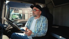 Senior truck driver using truck gps navigation to looks the route before leaving. Right hand drive car - Powered by Shutterstock - Get 15% off with code: PIKWIZARD15