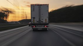 Time lapse of speedy truck with semi-trailer driving on highway along big city in evening time at sunset, rear view of cargo van. - Powered by Shutterstock - Get 15% off with code: PIKWIZARD15