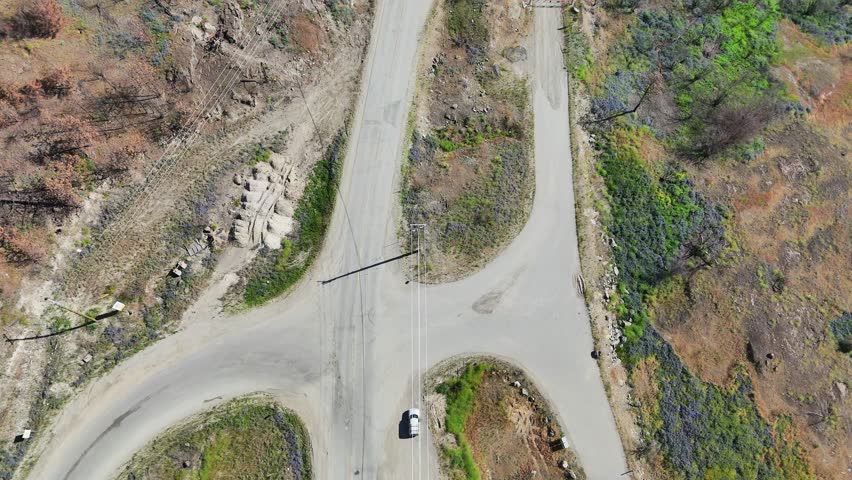 Aerial view (tilt up) of Westside Road near Okanagan Lake during a spring season in West Kelowna, British Columbia, Canada