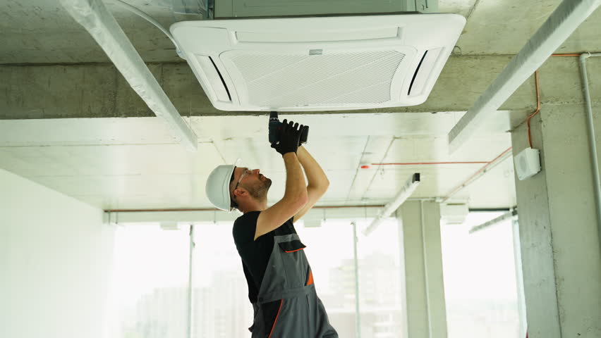 Technician worker repairing air conditioner in home or office