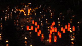 Red and orange paper Japanese lanterns on the water late at night in the dark - Powered by Shutterstock - Get 15% off with code: PIKWIZARD15