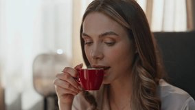 Morning lady sipping espresso in soft bed closeup. Relaxed female hands flipping pages putting coffee cup in cozy bedroom interior. Beautiful smiling woman taking tea sip enjoying breakfast at hotel - Powered by Shutterstock - Get 15% off with code: PIKWIZARD15