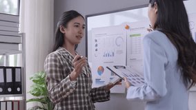 Two businesswomen discussing data analysis, reviewing charts, and analyzing statistics in a modern office. Professional teamwork and business collaboration with graphs and reports - Powered by Shutterstock - Get 15% off with code: PIKWIZARD15