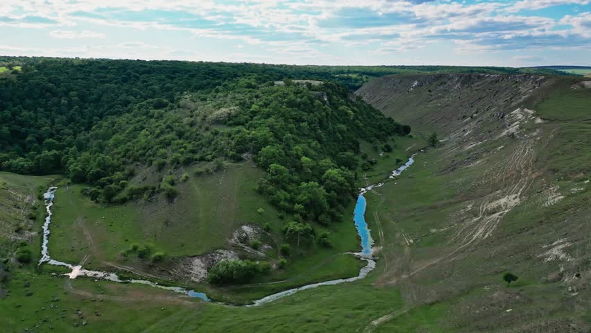 eautiful landscape of green-covered hills and a river. Drone footage showcases picturesque natural views, revealing the harmony of green hills and the tranquil flow of the river.